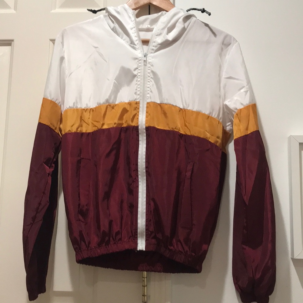 burgundy, white, and orange wind breaker
